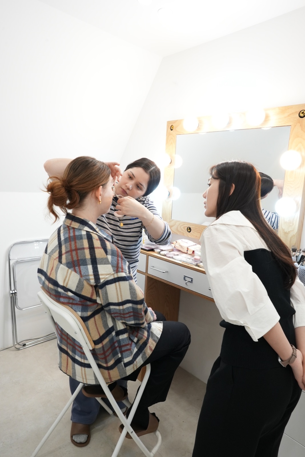 Instructor guiding a student through a makeup application